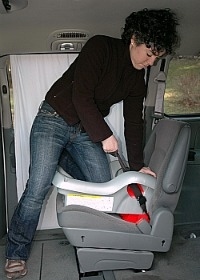 car seat installation putting knee in seat to use body weight