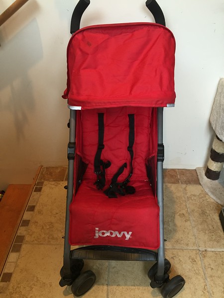 Joovy Groove Ultralight stroller in red shown from front view with shade fully extended