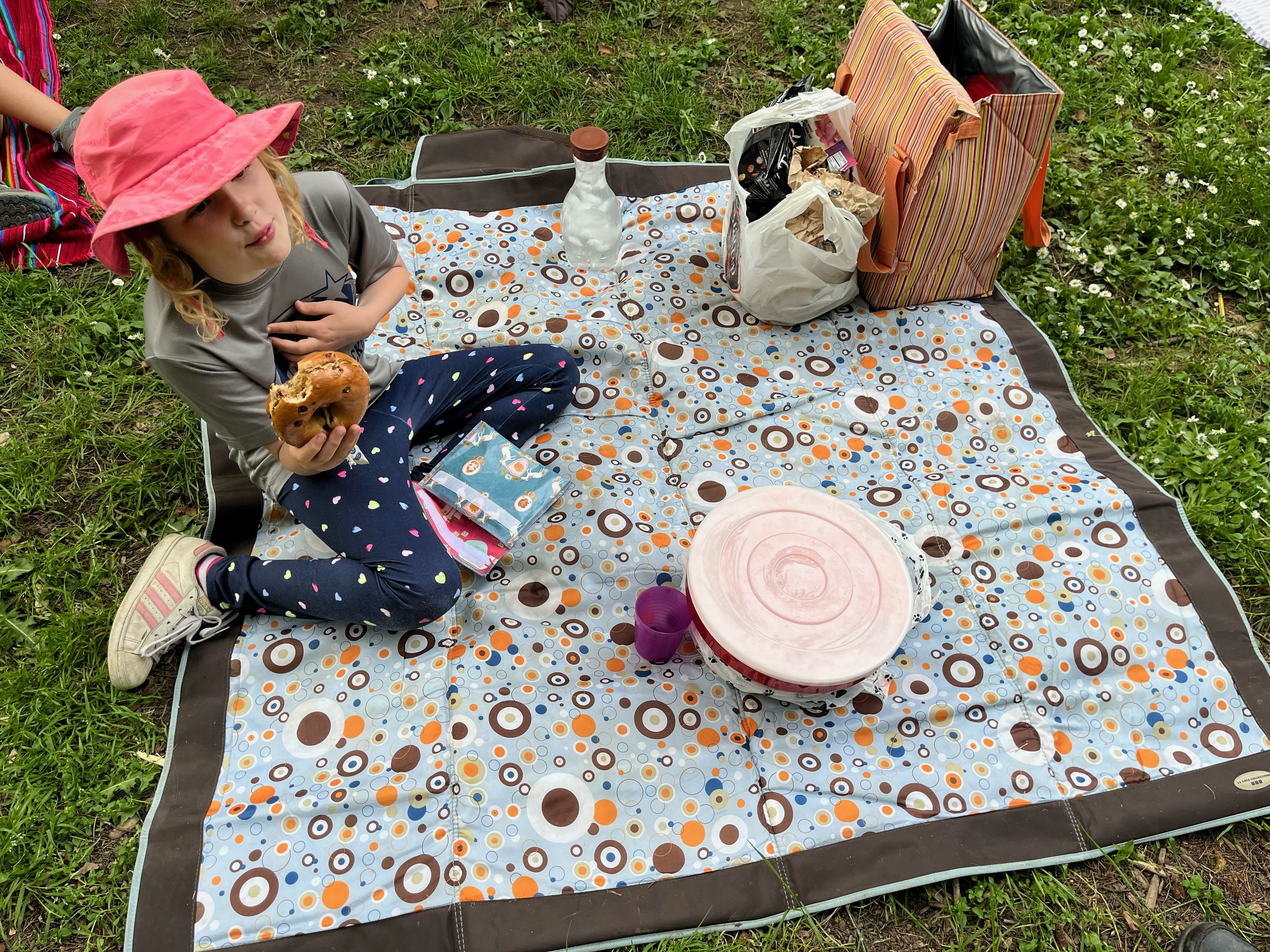 J.J. Cole picnic blanket with ten year old eating bagel