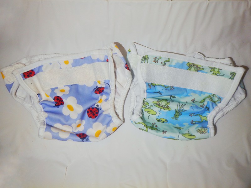 Two Bummis Super Whisper Wrap diaper covers shown side by side on a flat surface