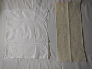 Bumkins flushable diaper liner shown next to Bummis flannel reusable diaper liner