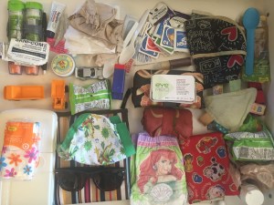 Contents of diaper baby changing bag laid out on flat surface