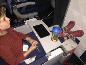 A six abd a half year old with his feet propped up using the JetKids BedBox