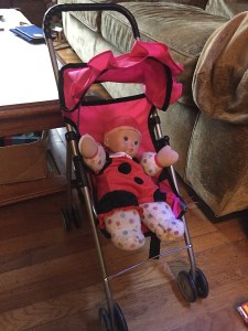 Baby Stella ladybug costume clothes on soft doll in stroller