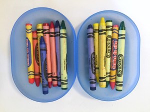 Crayons shown in two halves of a travel soap dish box case