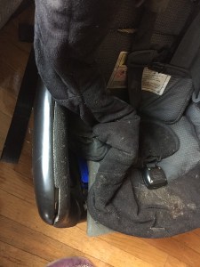 Lock off peeking out from under the convertible car seat padding