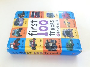 First 100 Trucks board book by Roger Priddy laying on its side