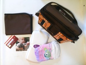 Reese Li changing clutch purse bag and contents of changing mat diaper wipes credit card photo shown