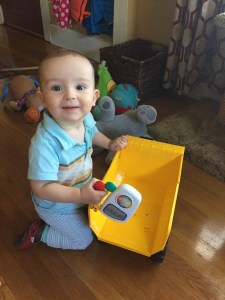 Toddler playing with Tonka steel mighty dump truck