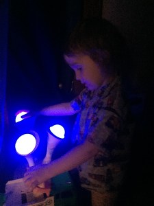 Child touching Boon Glo nightlight on the blue setting