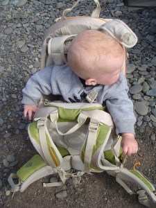 Infant riding in Kelty Kids FC 3.0 backpack carrier on the ground