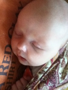 Sleeping infant in ring sling as seen from above