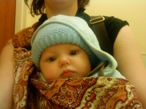 Infant facing out in ring sling