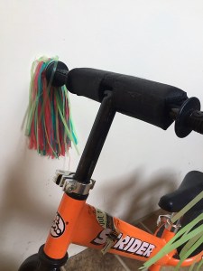 Strider balance bike handlebars with padding and streamers