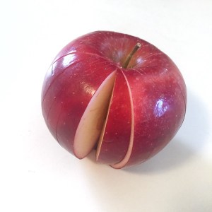 Sliced apple in apple shape missing one wedge piece