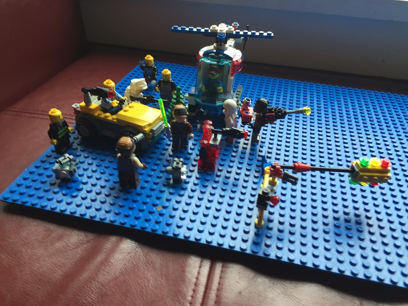 Blue Lego brick base plate with mini figures preparing for battle
