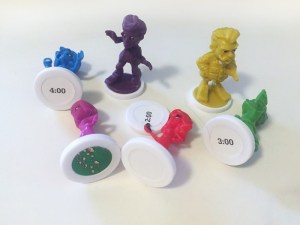 Different color characters on white bases with times from Clue Junior board game