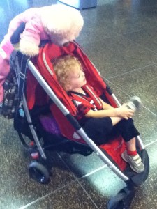 Stroller loaded with stuff for travel including toddler