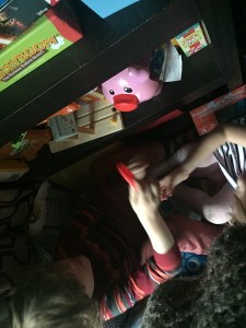 Elementary kids playing with fisher price laugh and learn piggy bank and coins