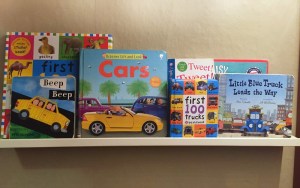 Books displayed on white picture ledge shelf