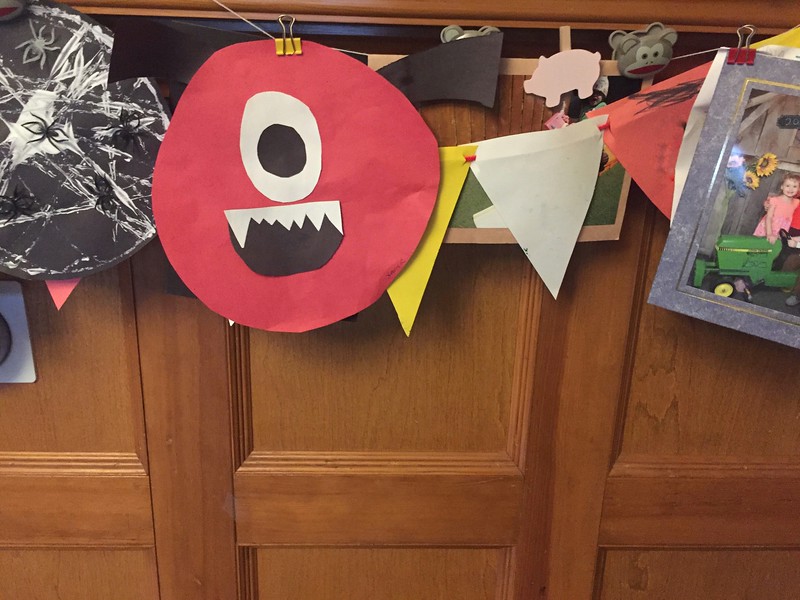 Child's art hung from string with clips to display