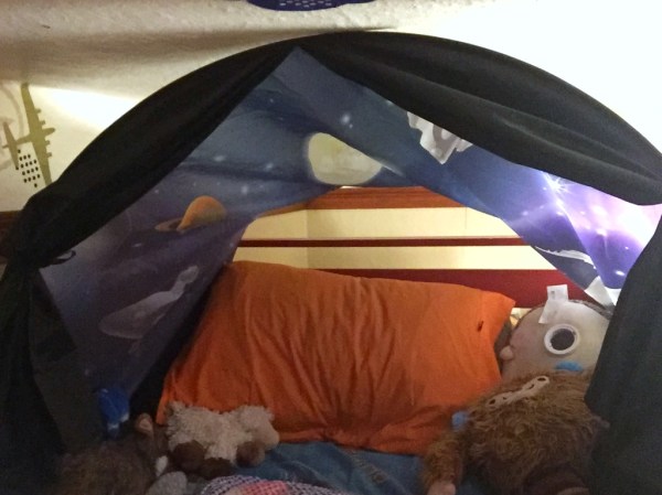 Dream tent in space adventure set up in loft bed bed with curtains tied back