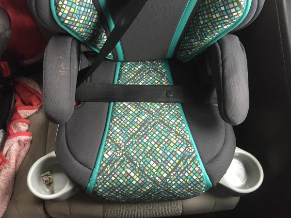 Graco Turbobooster booster car seat bottom portion with seatbelt fastened over it and cup holders extended