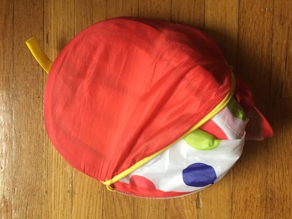 Kuuqa Kids pop up toddler ball pit folded and partially inside zippered storage bag