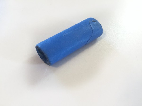 Blue painters' tape rolled up into small cylinder for travel