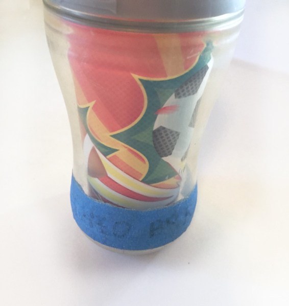 Sippy cup playtex labeled with blue painters tape