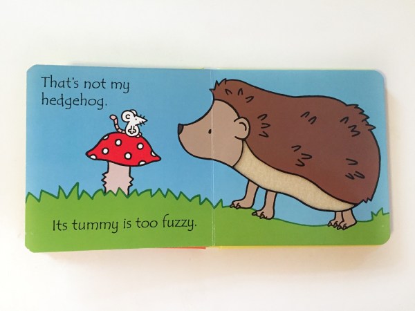 Hedgehog with fuzzy tummy texture sniffing mushroom in Usborne That's Not My Hedgehog book