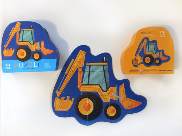 Crocodile Creek digger ten piece puzzle assembled and shown with both sides of included storage box