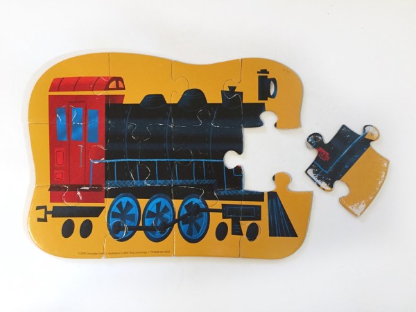 Locomotive train twelve piece puzzle from Crocodile Creek with one piece left unassembled