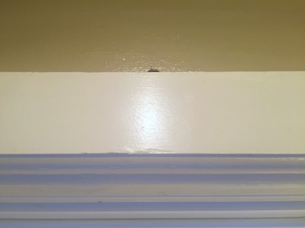 Windowsill with small key peeking over the edge