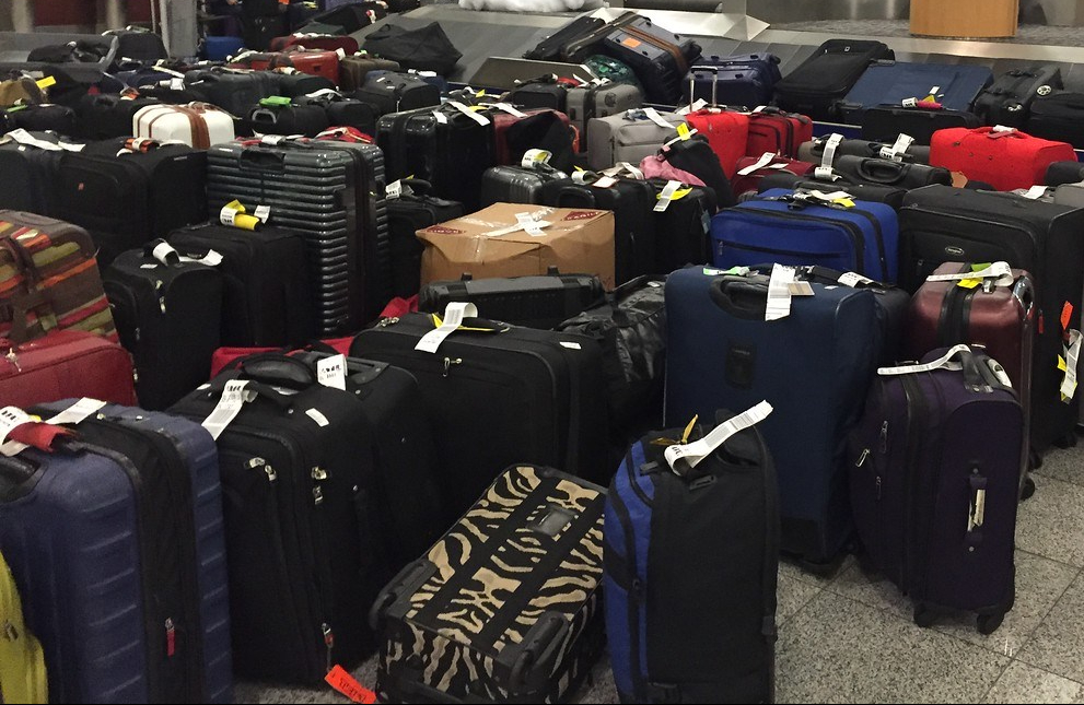 Suitcases stacked in rows at airport arrivals baggage claim