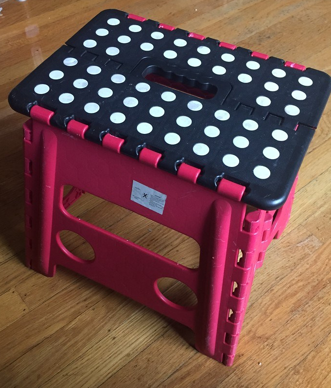 Acko step stool folding compact red with black surface and white dots