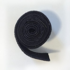 Velcro hook and loop fastening tape rolled up in black