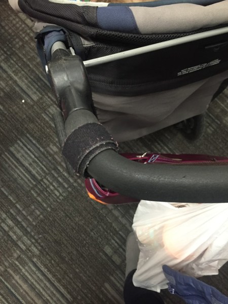 Velcro fastening tape wrapped around stroller handle