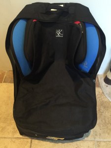 Car seat travel bag on wheels loaded with Britax marathon convertible car seat