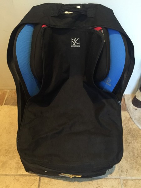 Car seat travel bag on wheels loaded with Britax marathon convertible car seat