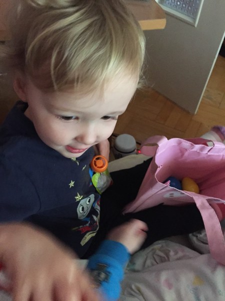 Preschooler digging through Easter bag during trip abroad