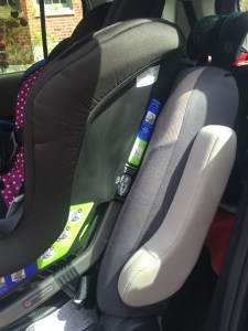 Middle row bucket seat with convertible car seat installed as viewed from side angle