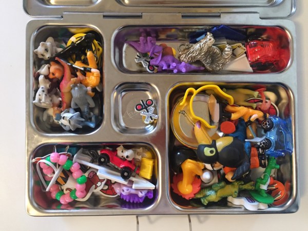 Tiny toys inside compartments of lunch box