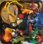 Tiny toys choking hazard stored in pile inside divided lunch box