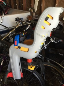 Topeak Baby bicycle seat attached over real wheel of bike