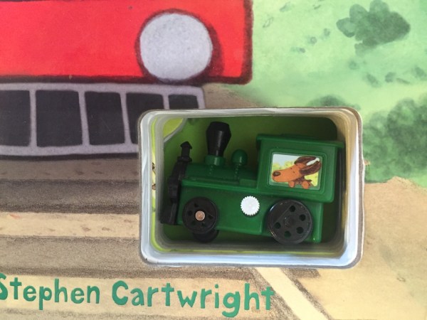 wind up train stored in cut out space of usborne book