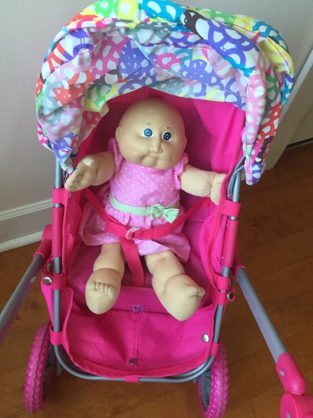 Doll strapped into upright sitting position on Lissi city stroller