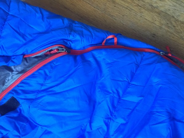 Close up of double zipper on REI Nodder blue kids sleeping bag