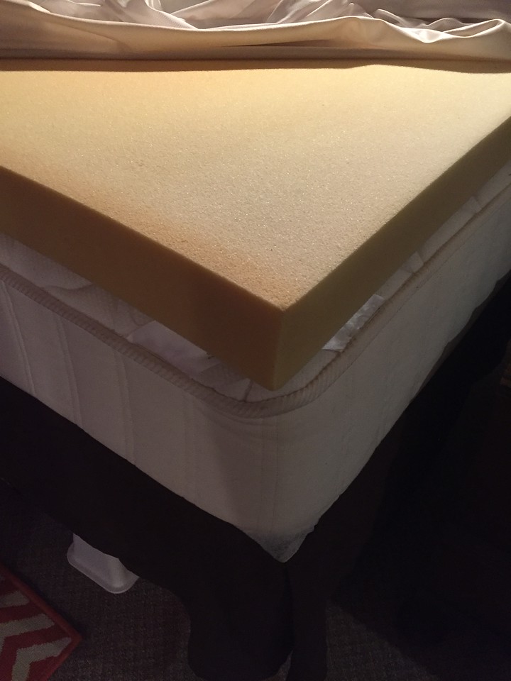 Four inch yellow foam bed topper on queen bed mattress