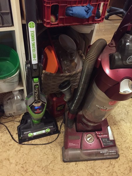 Bissell Bolt Pet Lithium cordless stick vacuum next to regular full size corded vacuum